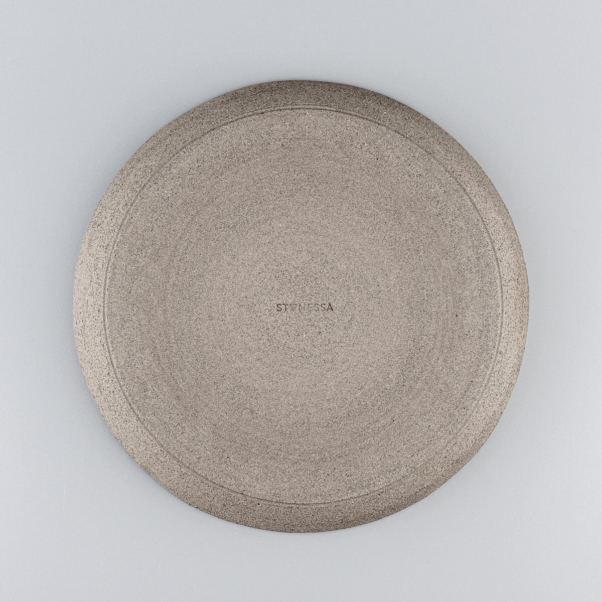 Underside of handcrafted stoneware plate showing natural finish.