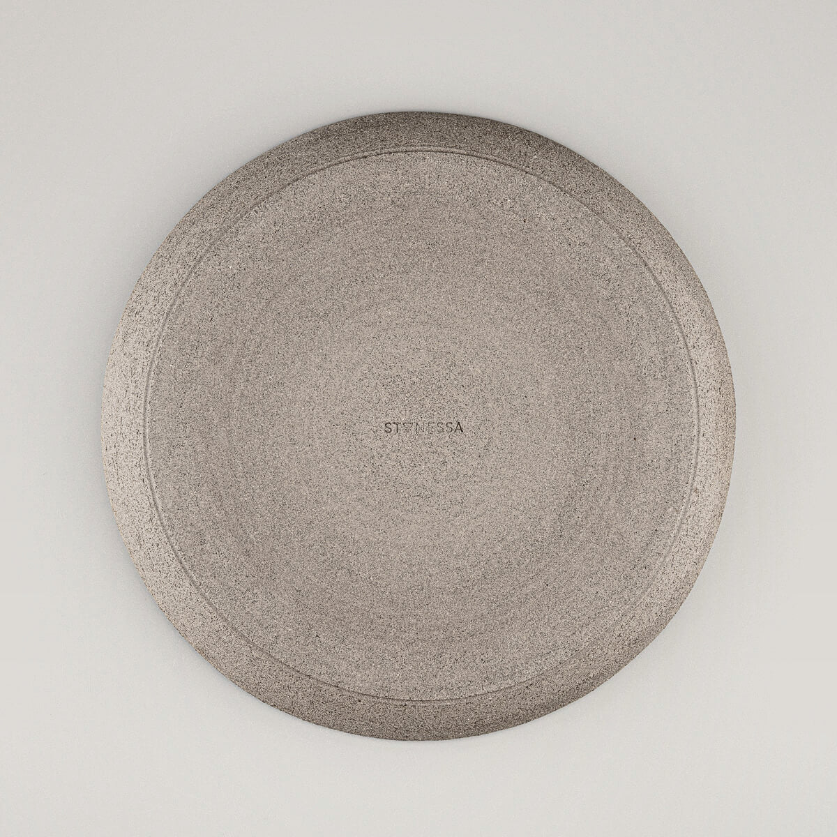 Underside of handcrafted stoneware plate showing natural finish.