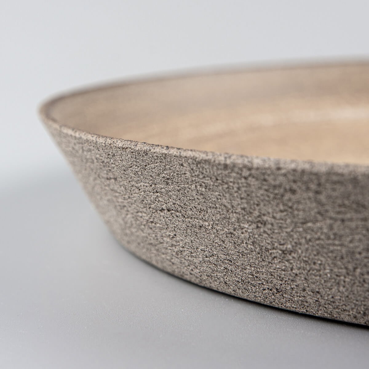 Matte ocher glazed stoneware plate with artisan craftsmanship for fine dining.