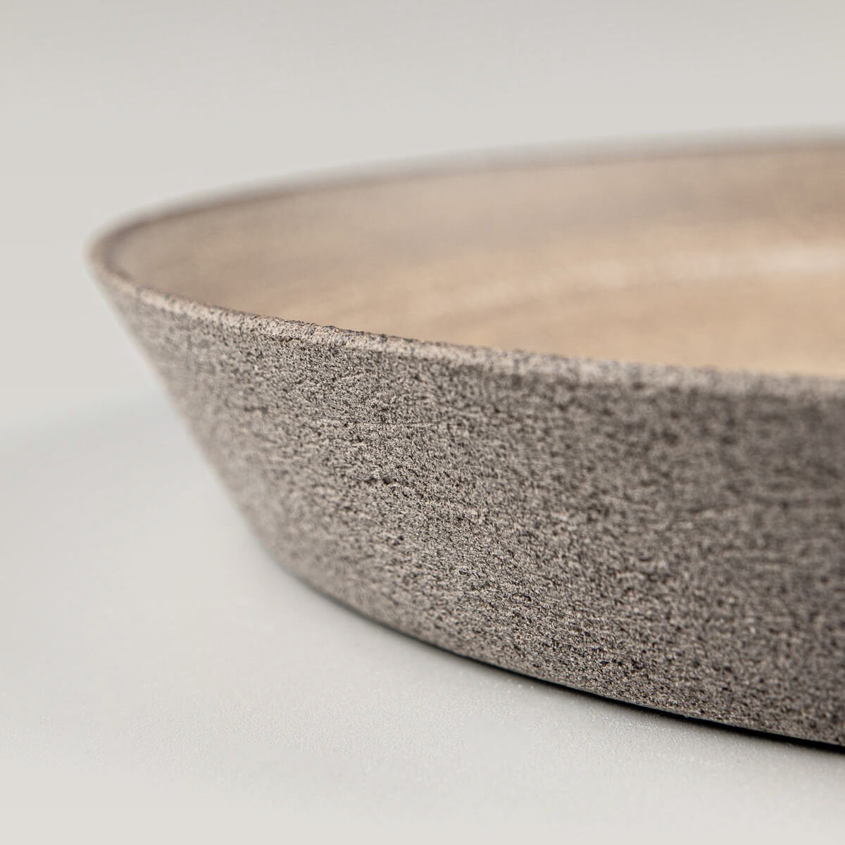 Matte ocher glazed stoneware plate with artisan craftsmanship for fine dining.