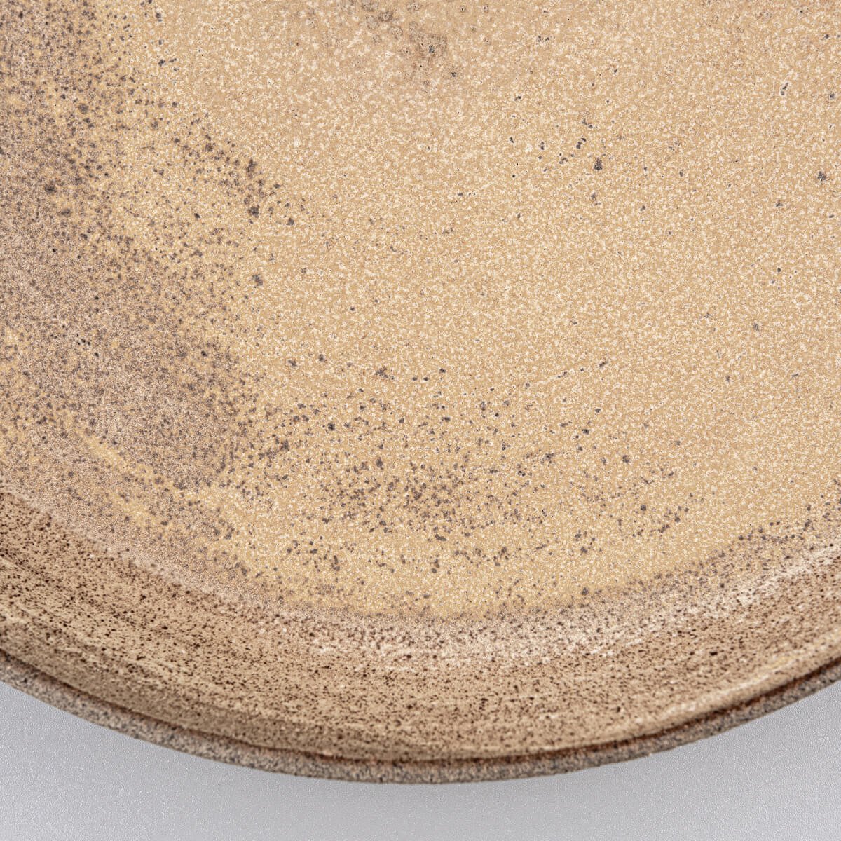 Rustic yet refined stoneware dinner plate with coupe design for luxury dining.