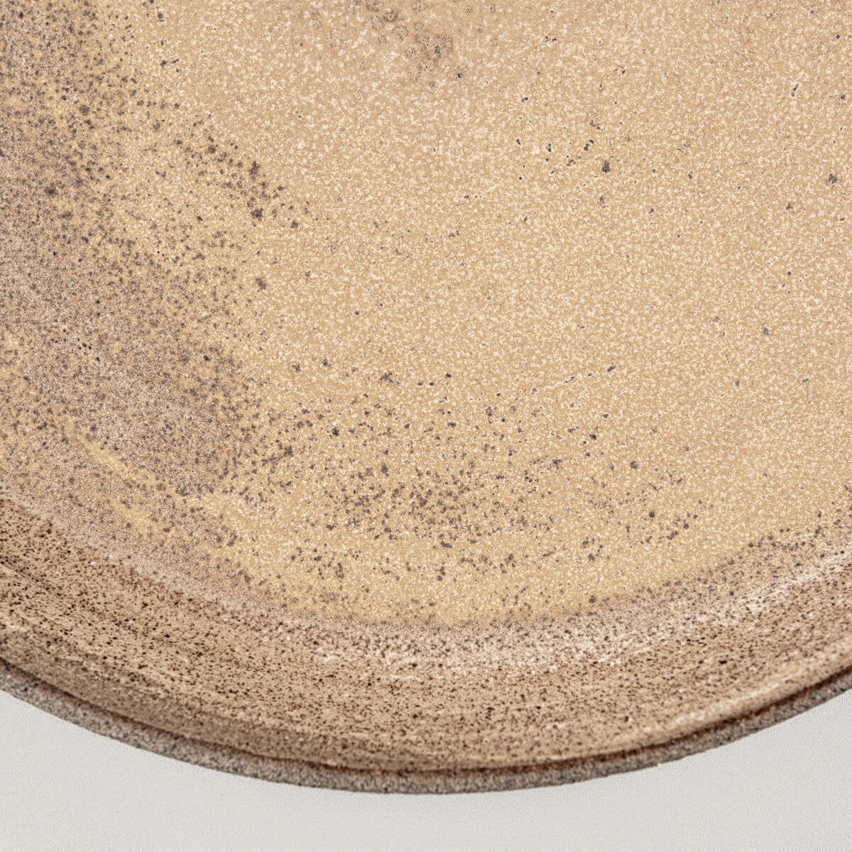 Rustic yet refined stoneware dinner plate with coupe design for luxury dining.