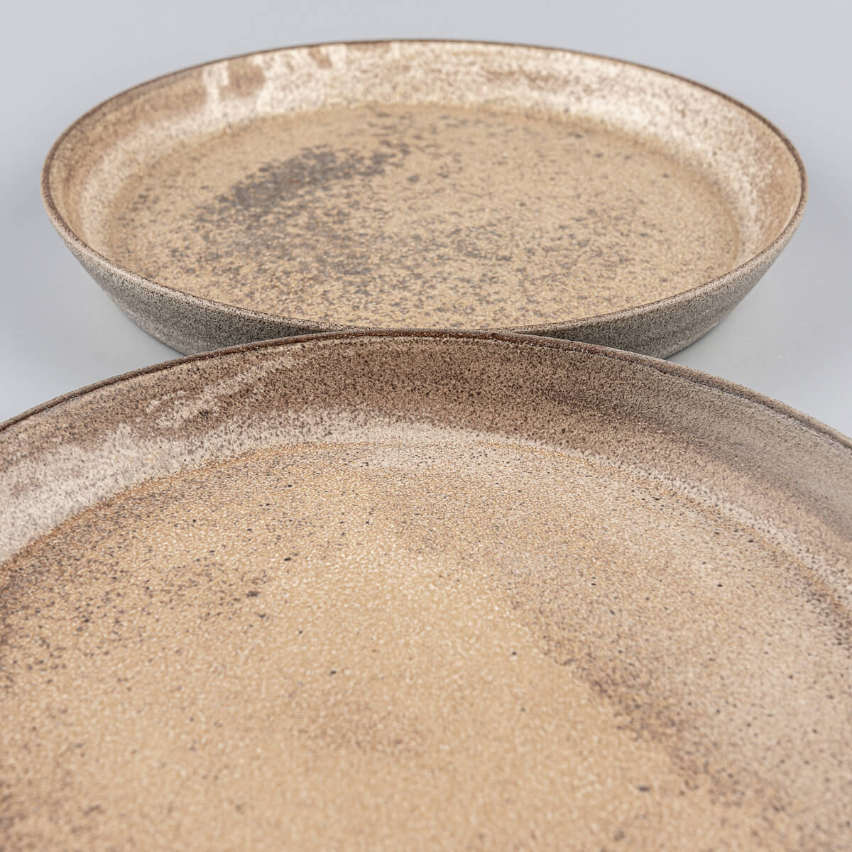 Detail of matte ocher glaze on handmade stoneware plates.