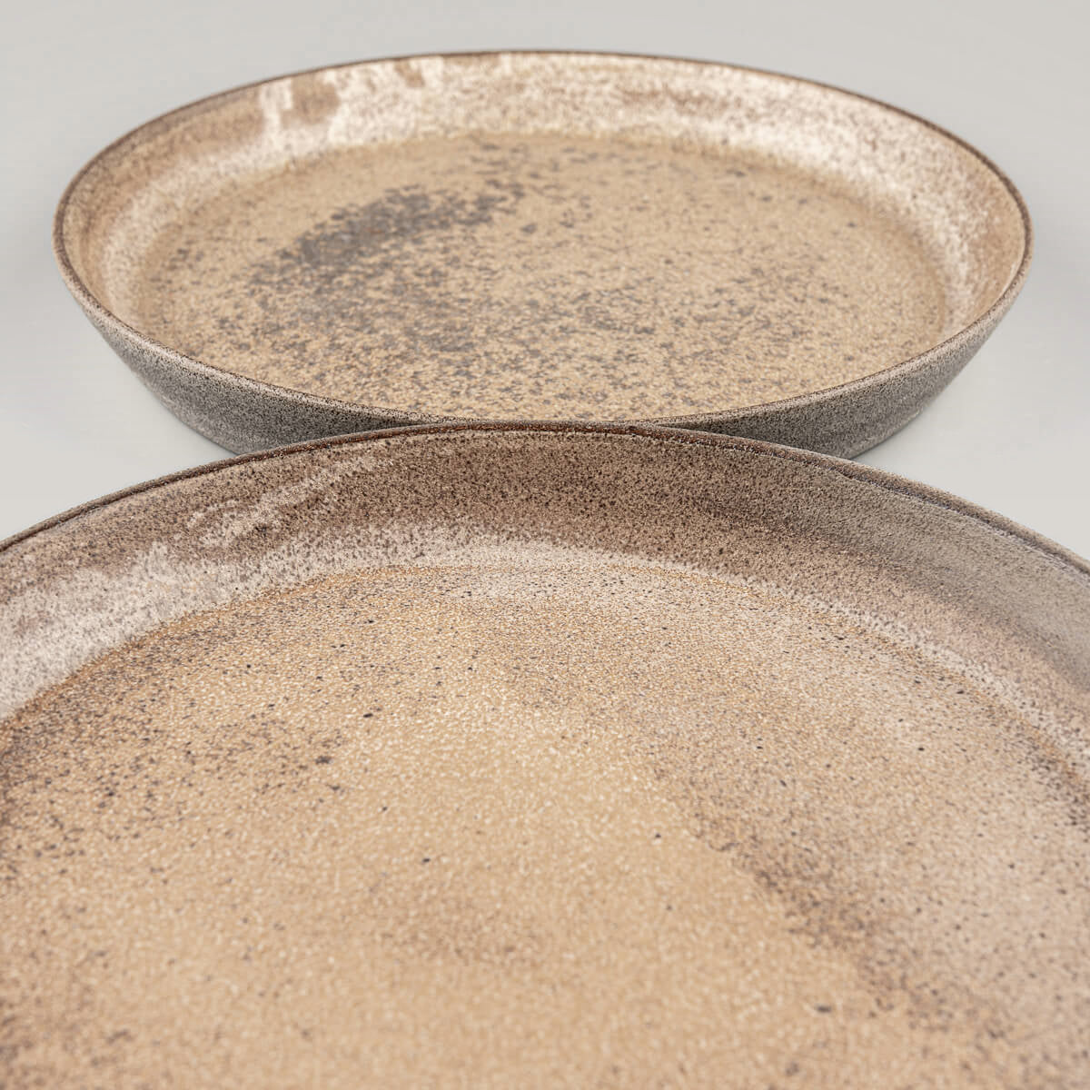 Detail of matte ocher glaze on handmade stoneware plates.