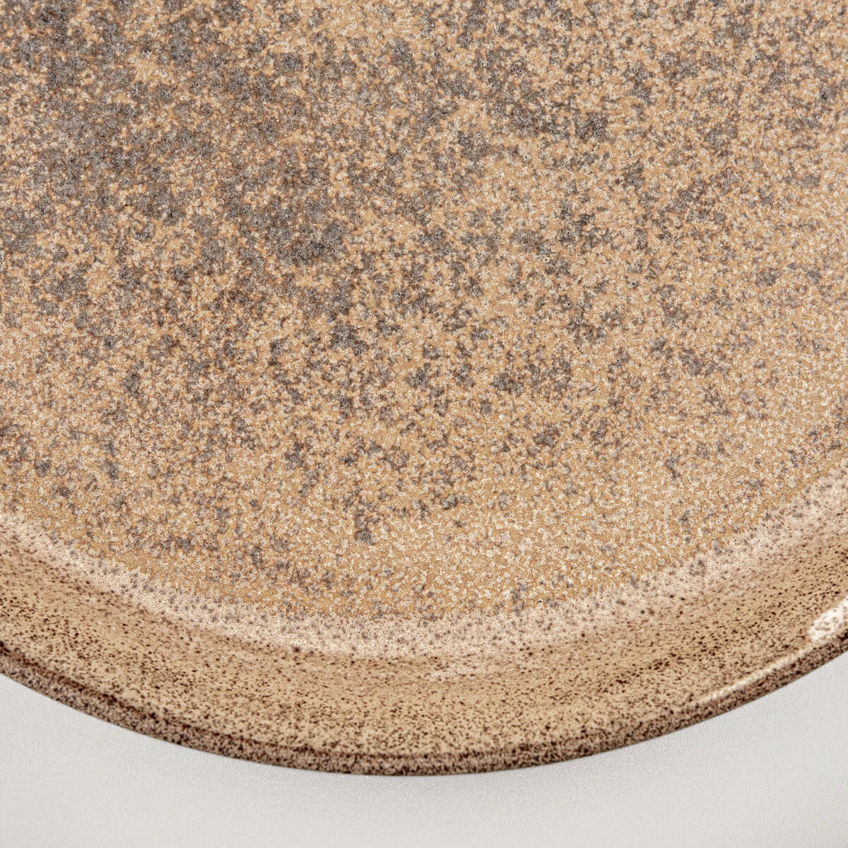 Textured center of stoneware dinner plate with artisanal glaze finish.