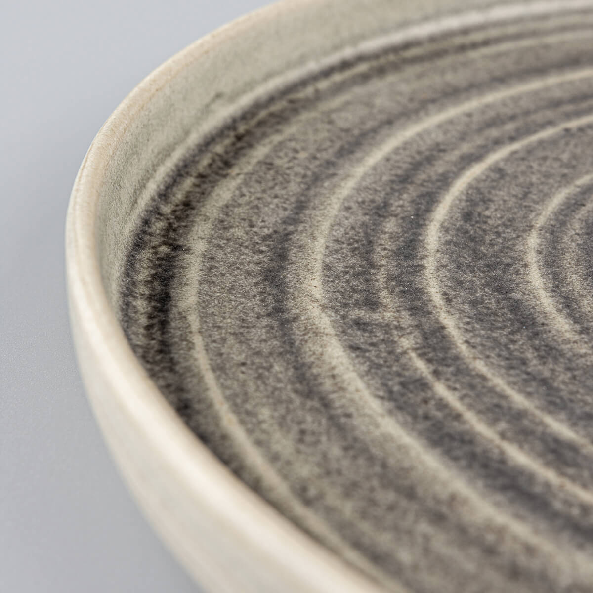 Detail of spiral pattern on luxury handcrafted ceramic tableware for professional chefs.