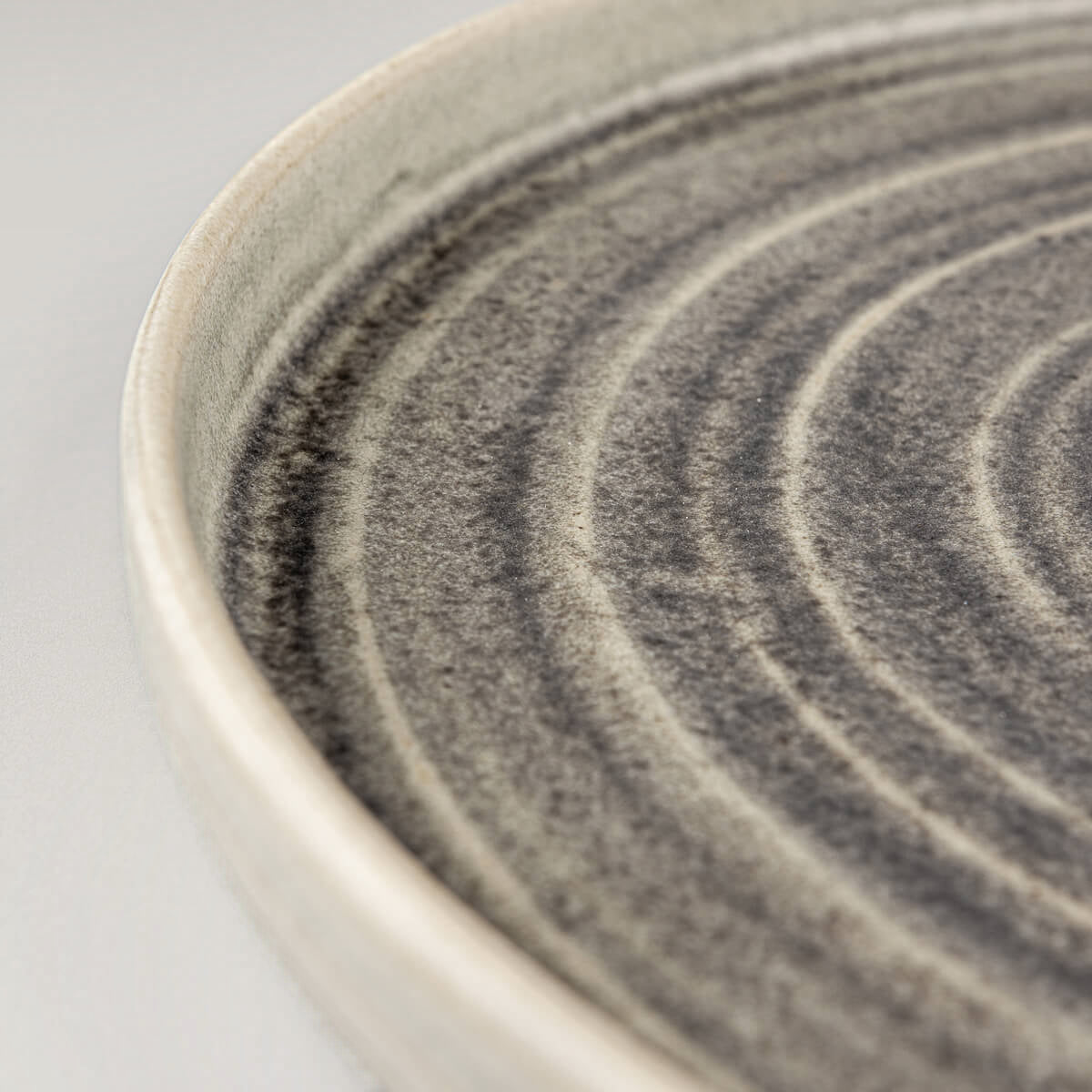 Detail of spiral pattern on luxury handcrafted ceramic tableware for professional chefs.