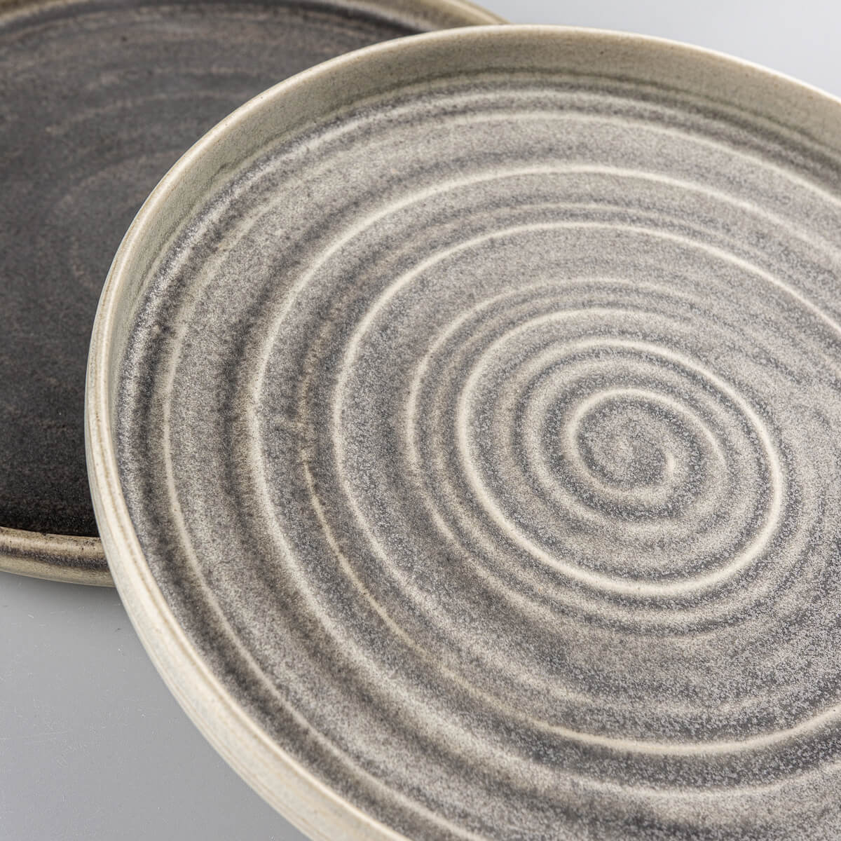 Premium handcrafted ceramic plates with spiral texture for luxury dining experiences.
