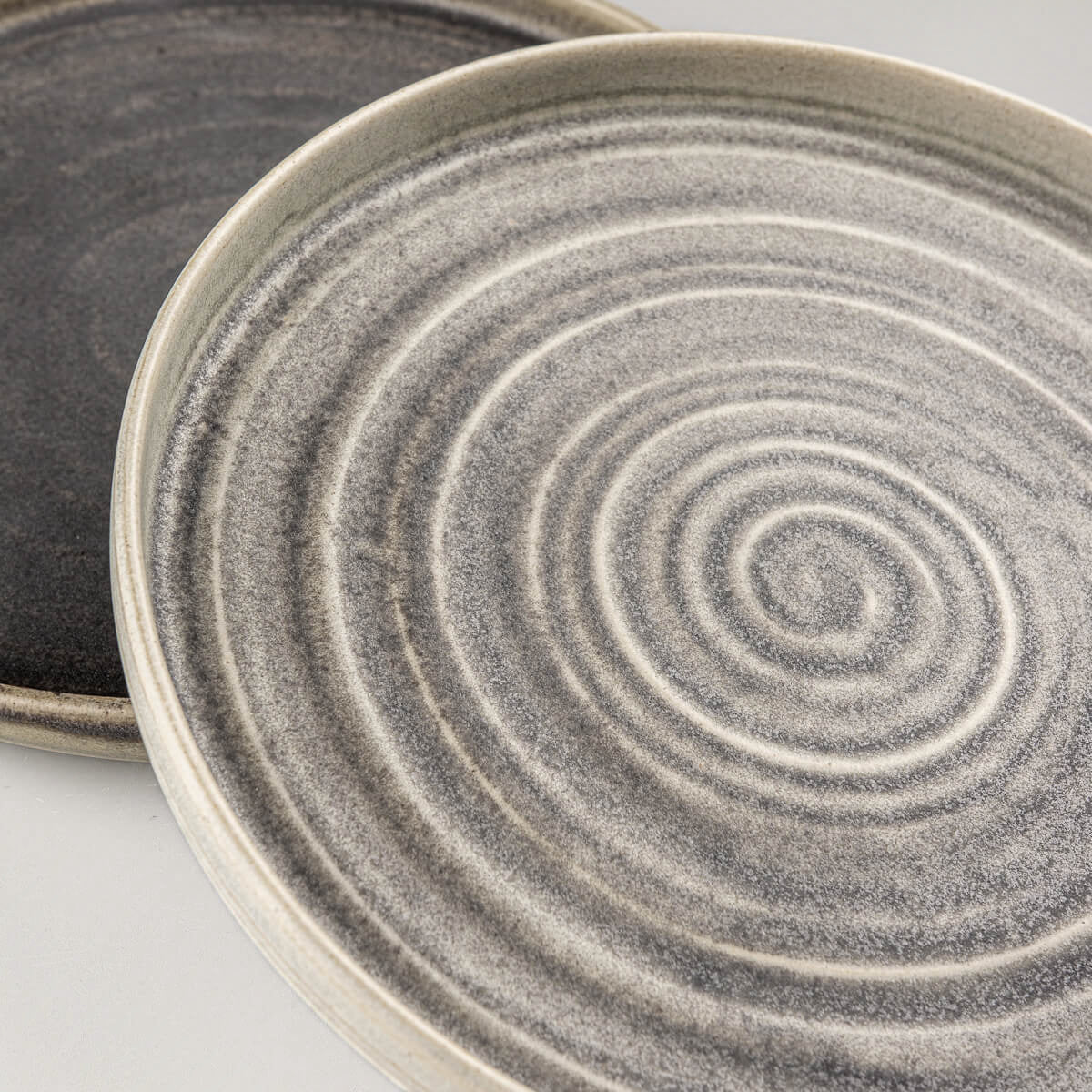 Premium handcrafted ceramic plates with spiral texture for luxury dining experiences.