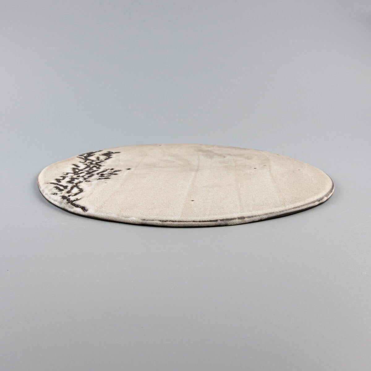 Close-up of plate edge revealing hand-etched texture for fine dining presentation.