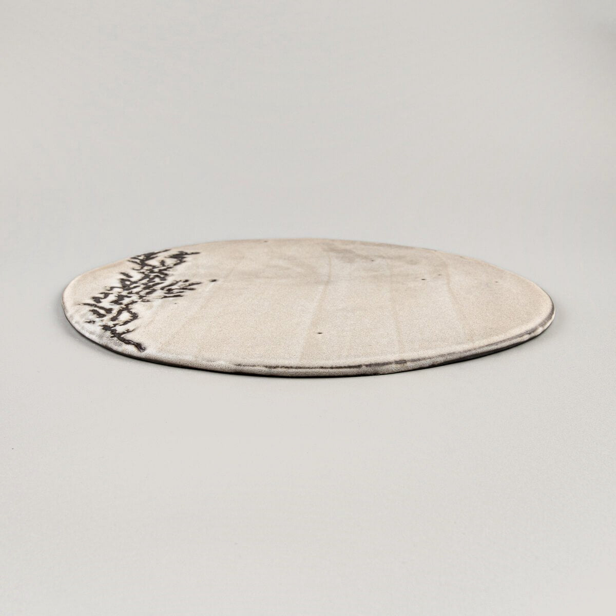 Close-up of plate edge revealing hand-etched texture for fine dining presentation.