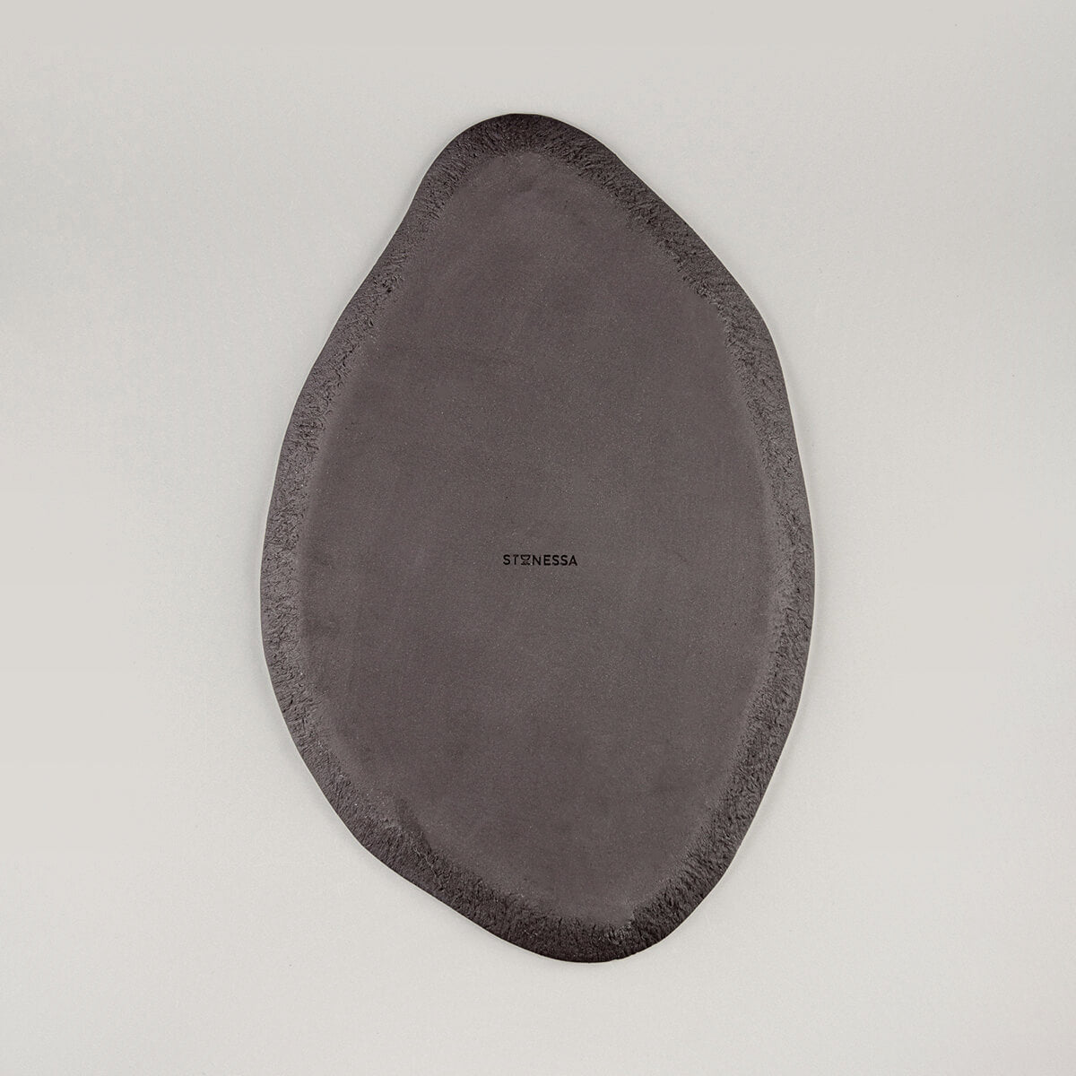 Back view of unglazed black stoneware clay showcasing artisanal craftsmanship.
