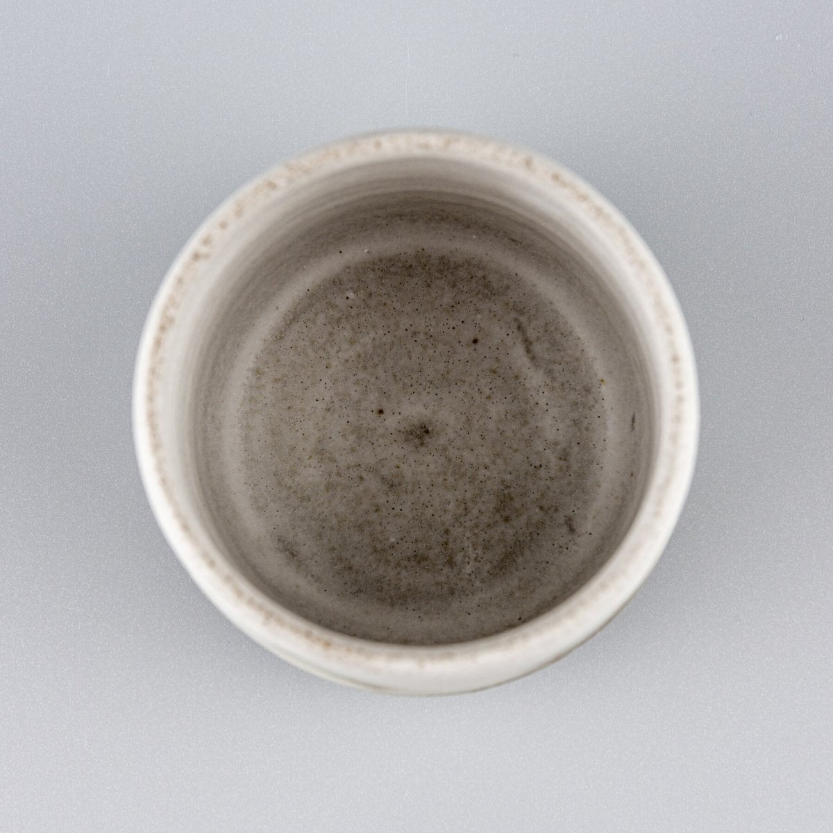 Handmade ceramic espresso cup photographed from top view, luxury stoneware tableware for restaurants and boutique hotels.