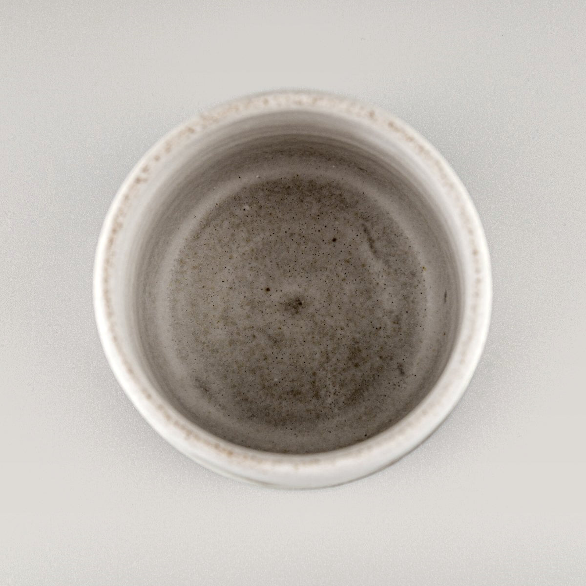Handmade ceramic espresso cup photographed from top view, luxury stoneware tableware for restaurants and boutique hotels.