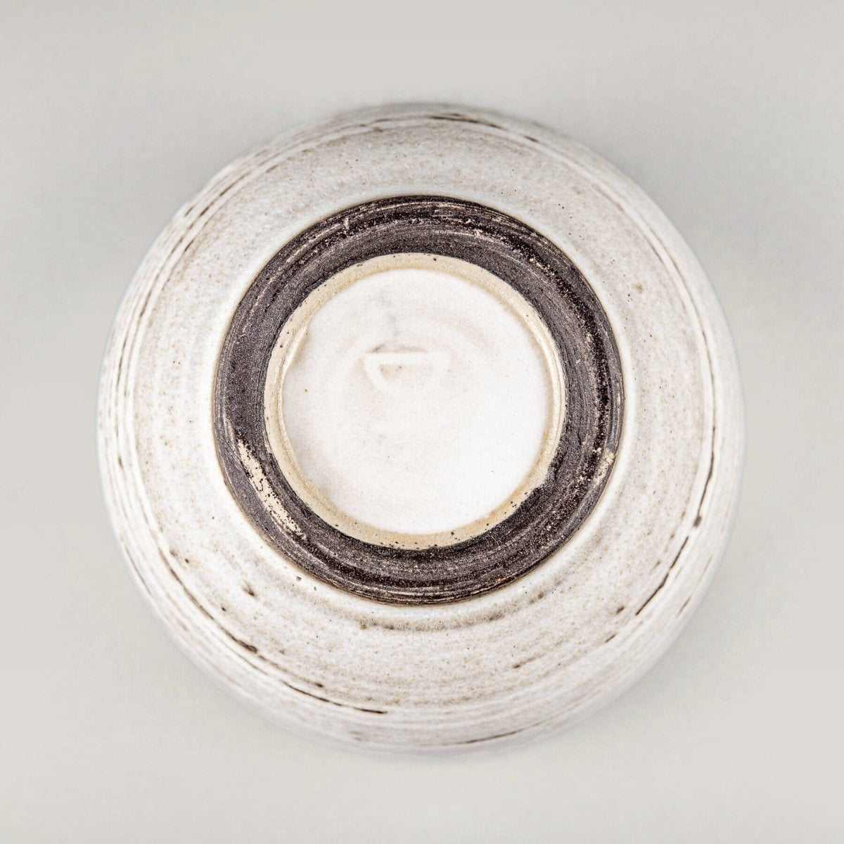 Handmade ceramic mug with white glaze and dark clay base, ideal for home, restaurant, and kitchenware use.
