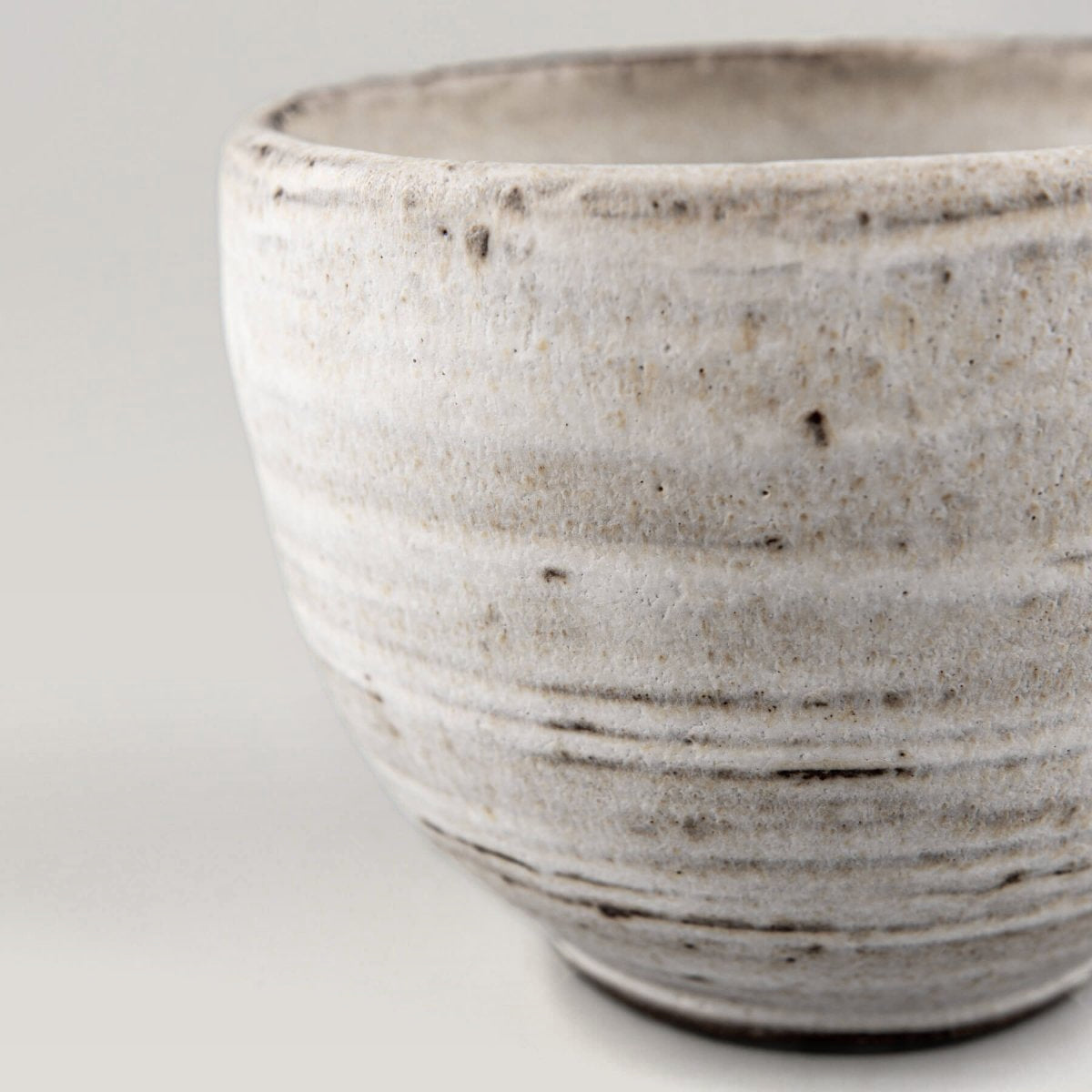 Unique stoneware mug with soft matte surface, blending functional tableware and collectible pottery.
