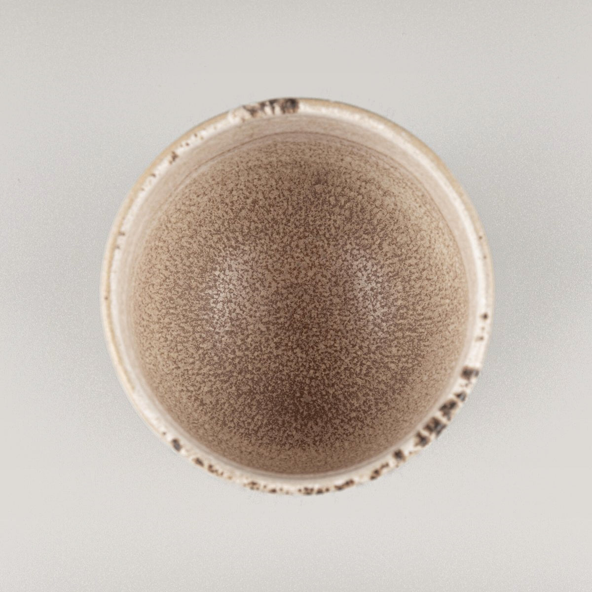 Top view of handmade stoneware coffee cup with matte glaze interior, perfect for restaurant and fine dining presentation.