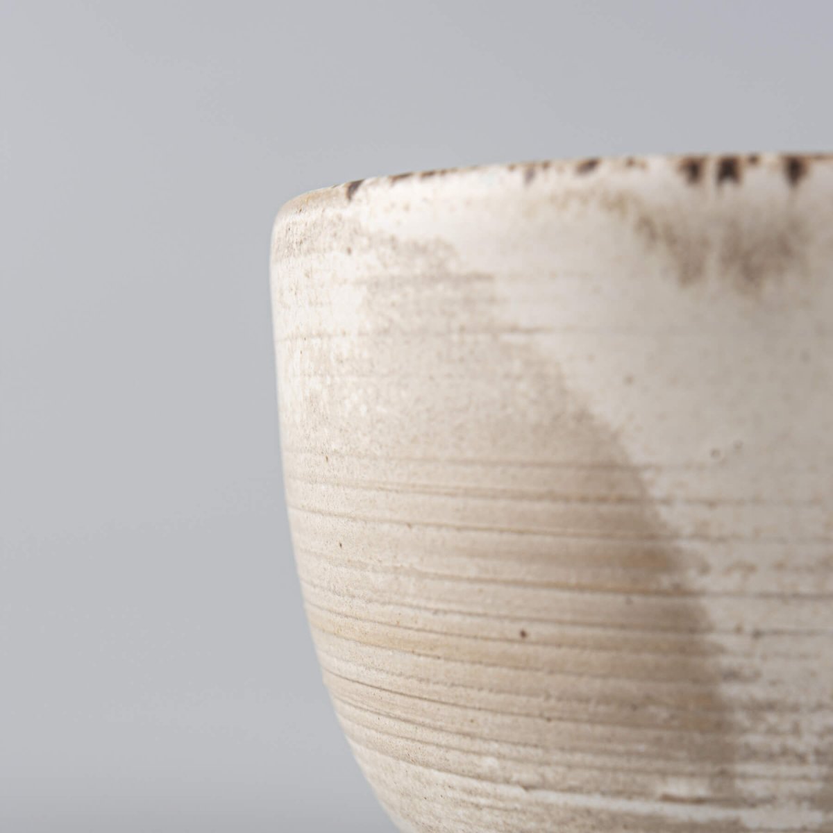 Minimalist handmade stoneware cup with earthy matte glaze, crafted for fine dining presentation.