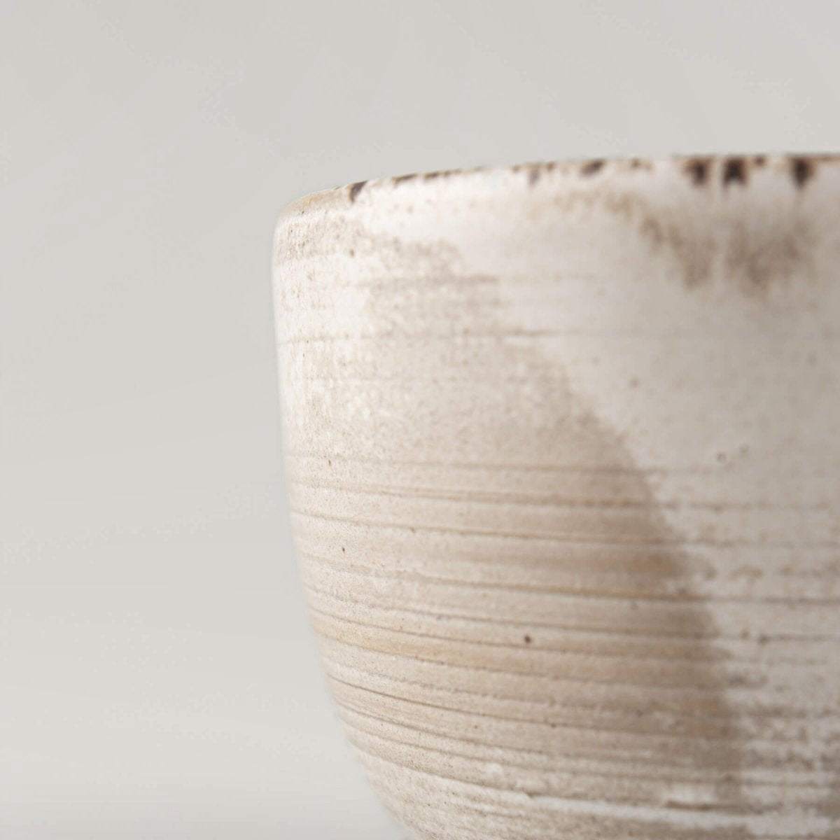 Minimalist handmade stoneware cup with earthy matte glaze, crafted for fine dining presentation.