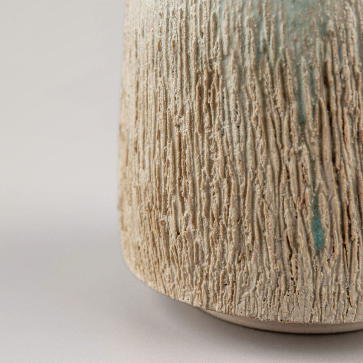 Elegant handmade pottery mug with rustic carving and aqua glaze, perfect as a wedding gift.
