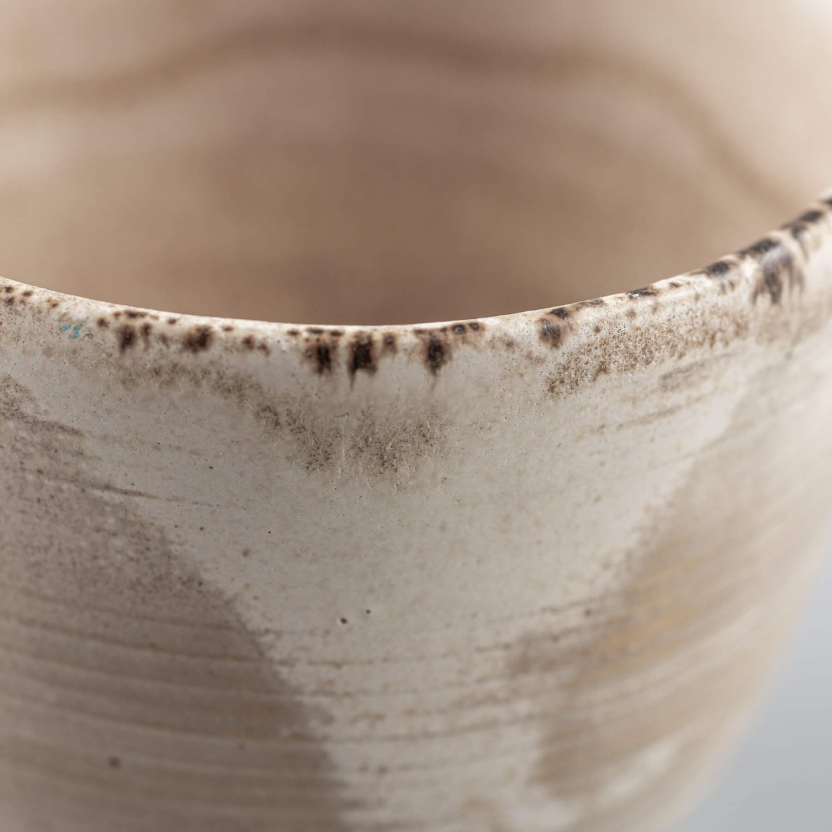 Handmade stoneware coffee cup rim with natural glaze details, ideal for fine dining and boutique hotel tableware.