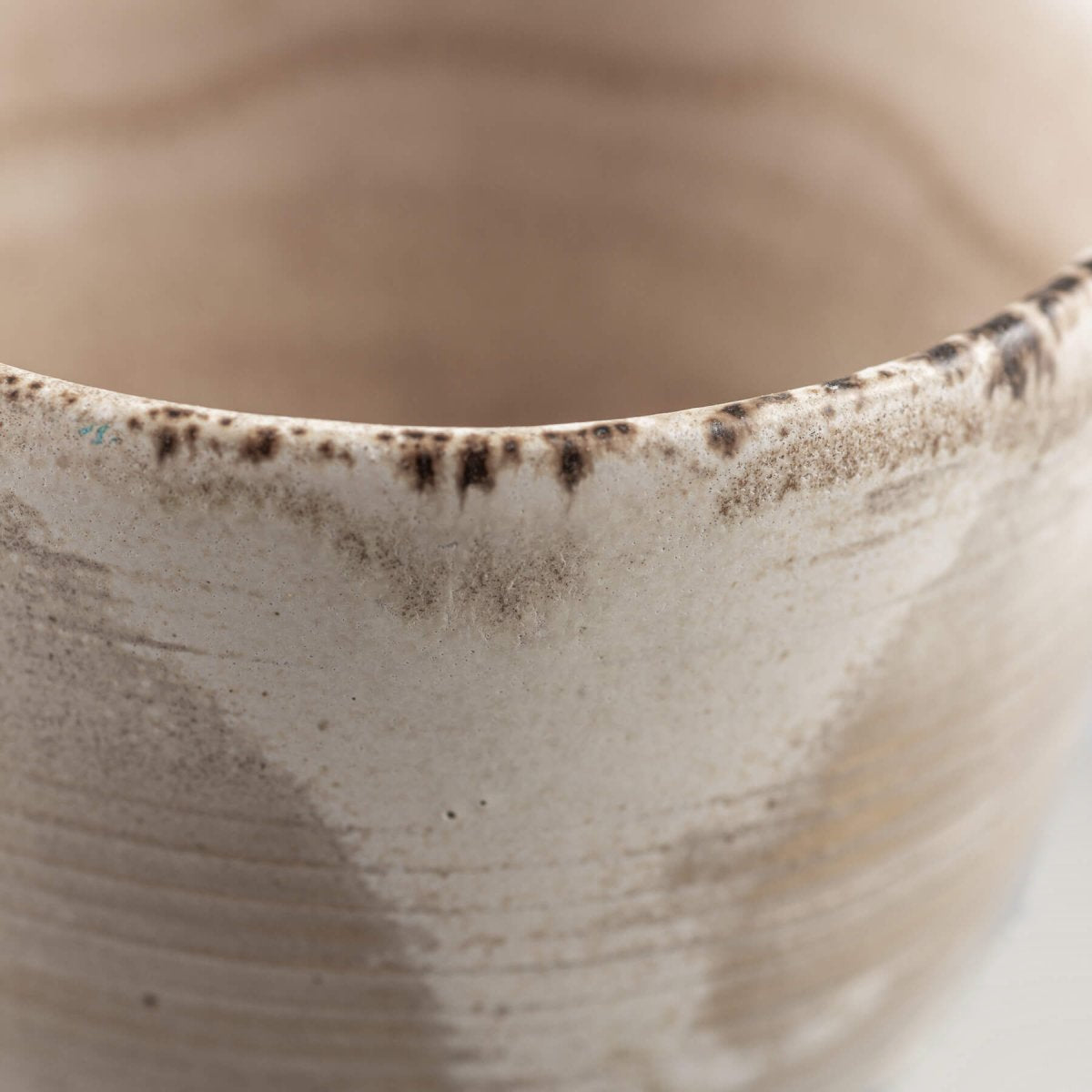 Handmade stoneware coffee cup rim with natural glaze details, ideal for fine dining and boutique hotel tableware.