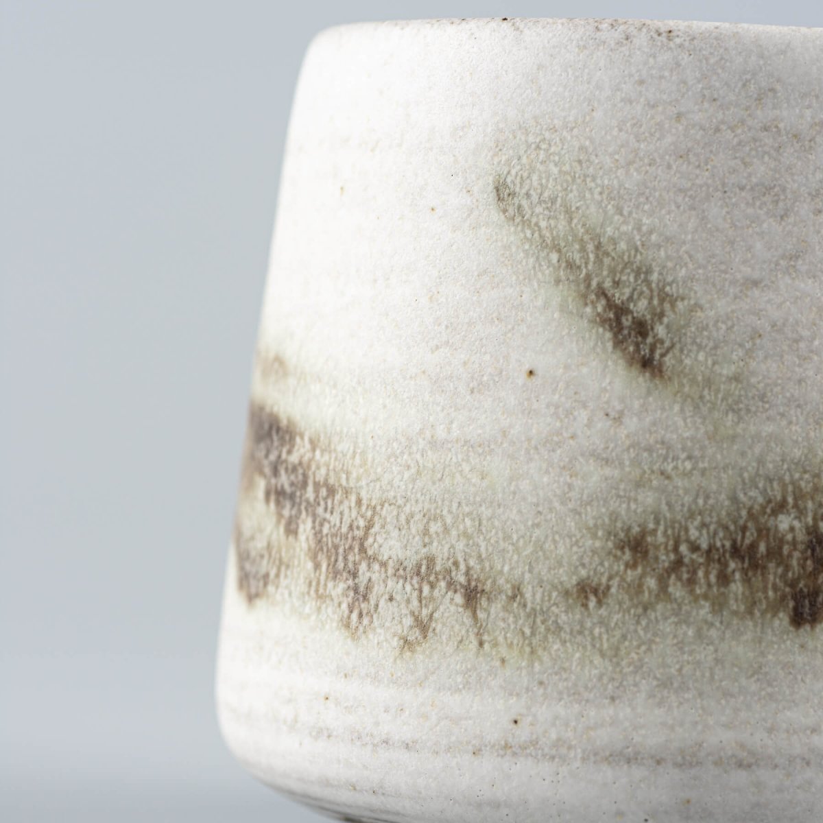 Unique stoneware espresso cup with unrepeatable glaze patterns for interior design and culinary presentation.