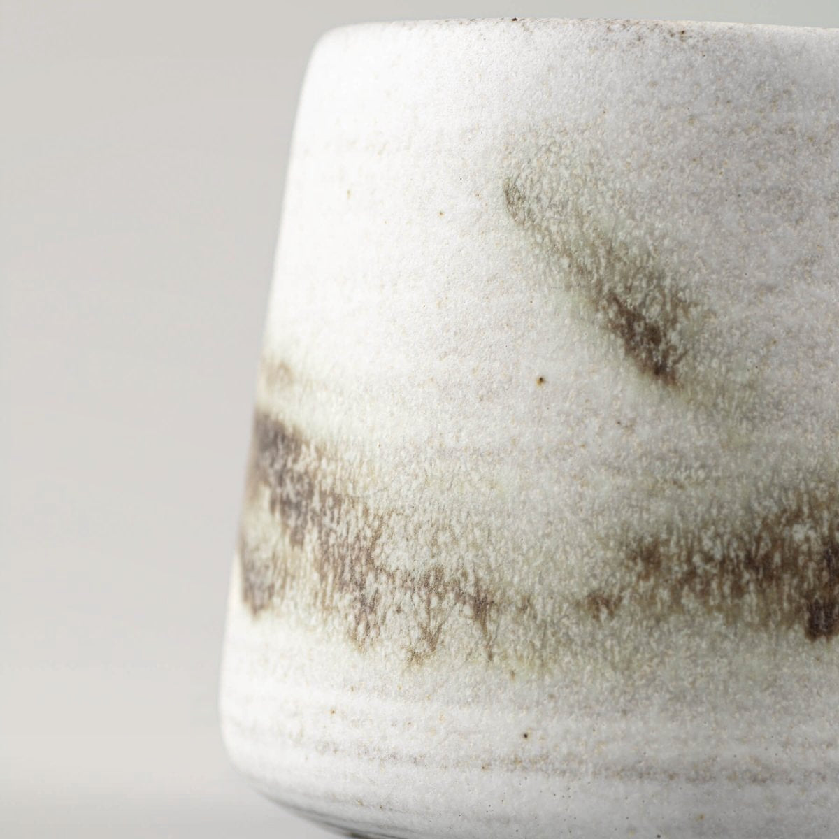 Unique stoneware espresso cup with unrepeatable glaze patterns for interior design and culinary presentation.