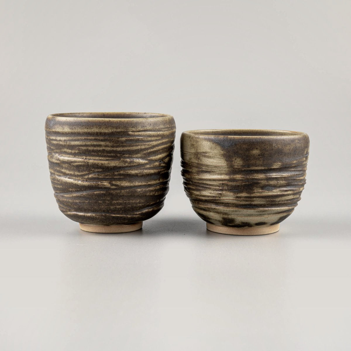Handmade ceramic mug with earthy olive glaze and textured exterior, perfect for home, hotel, or as a wedding gift.