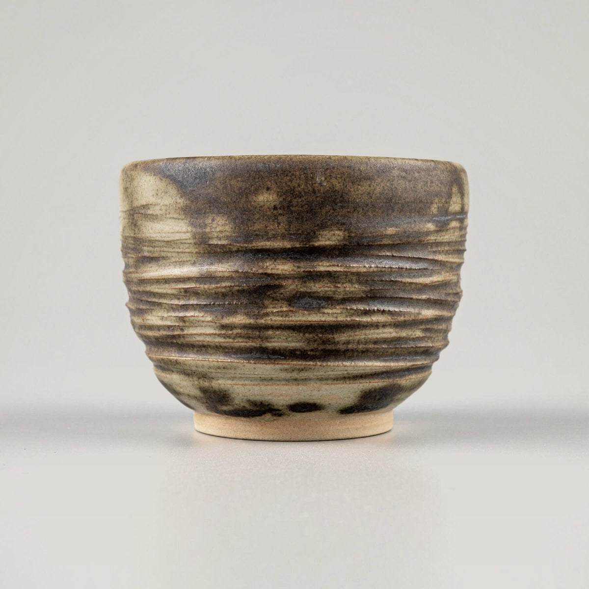 Handmade ceramic mug with earthy olive glaze and carved texture, ideal for coffee, tea, fine dining, and hotel tableware.