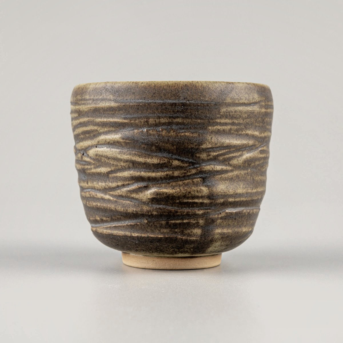 Rustic handmade ceramic mug set with engraved details, crafted for coffee, tea, and matcha in luxury dining settings.