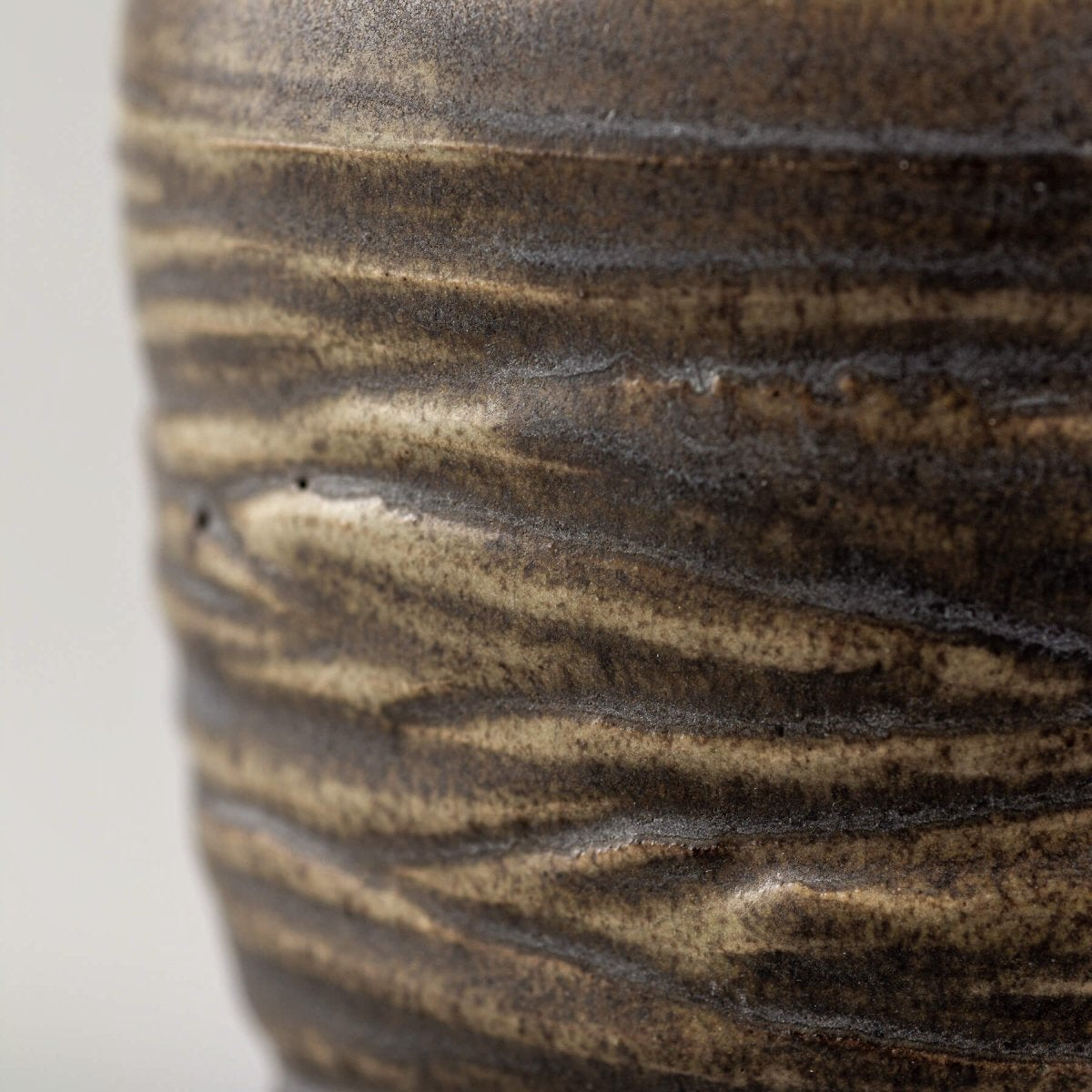 Detailed surface of handmade ceramic mug with rustic glaze, perfect for culinary presentation and fine dining rituals.