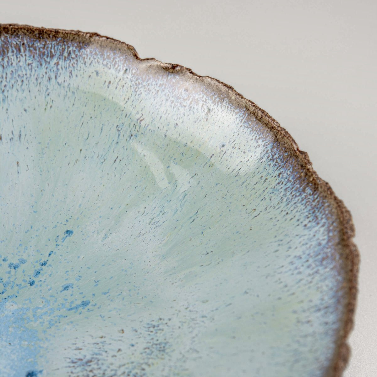 Angled view of bowl highlighting contrast between glaze and raw clay.