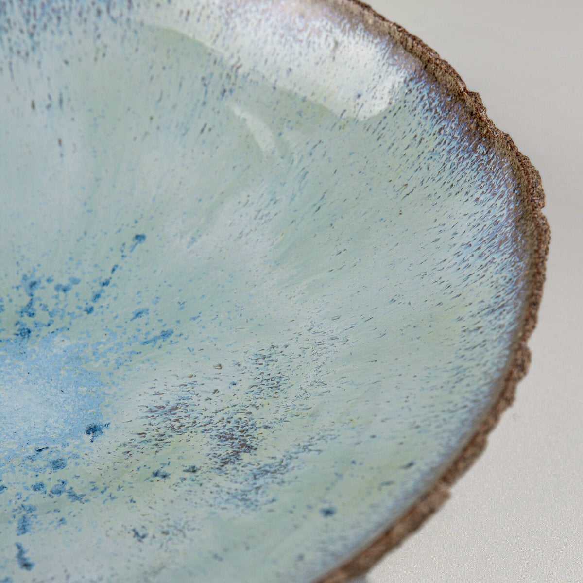 Interior rim detail with glossy glaze finish on artisan bowl.