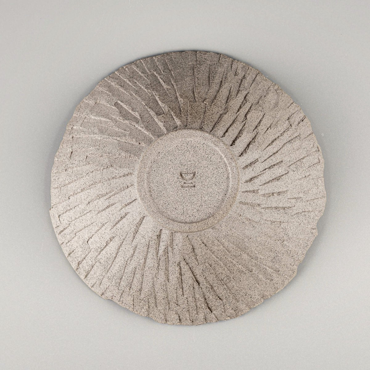 Bottom view of raw ceramic bowl showcasing potter’s wheel marks and collectible pottery appeal.