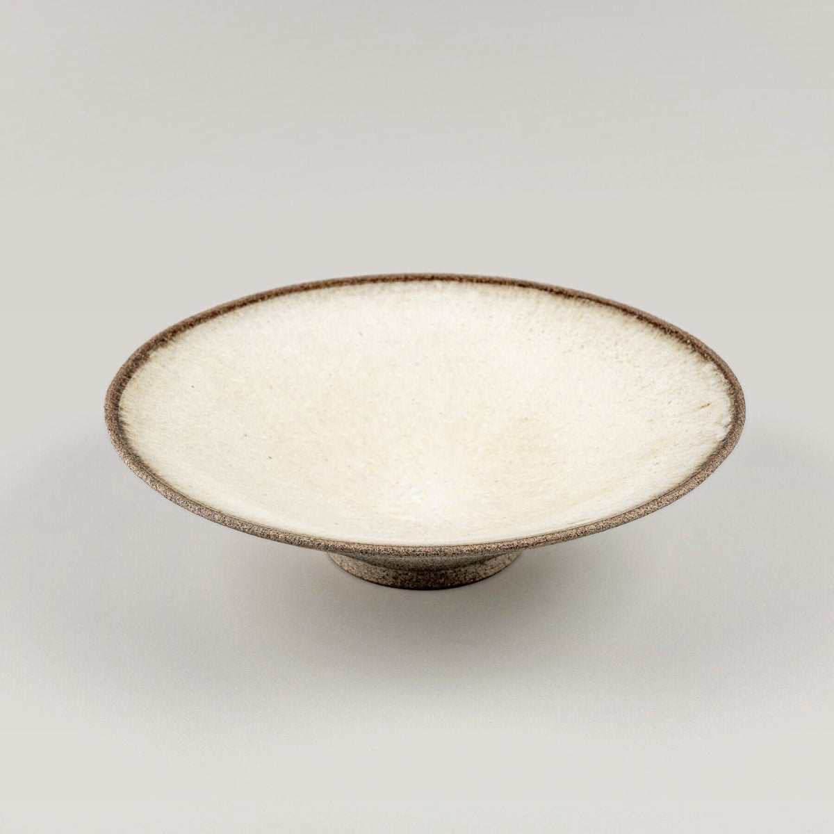 Top view of a ceramic plate with a smooth, white glazed surface for elegant plating.
