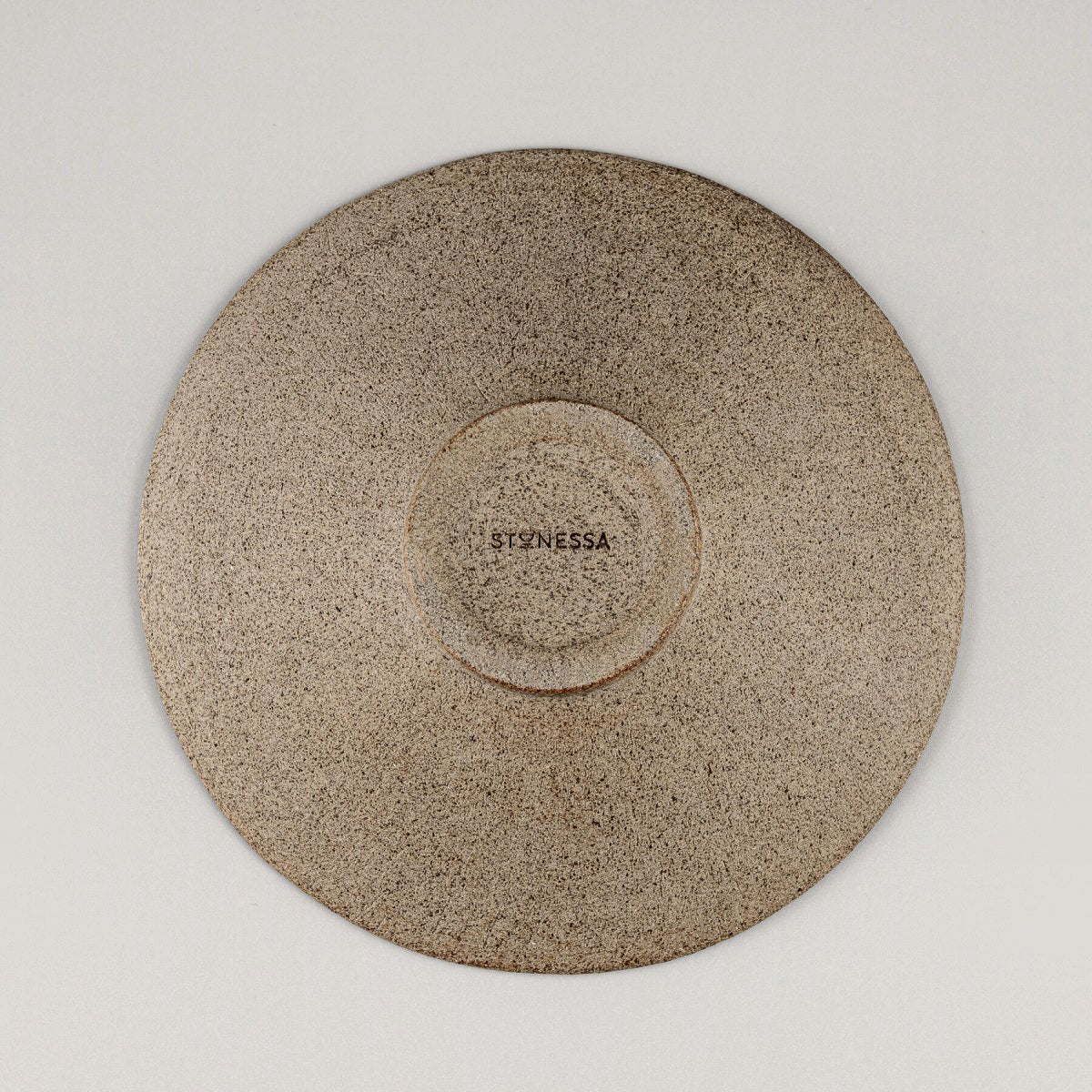 Base of artisanal ceramic plate with natural textured finish for fine dining restaurants.
