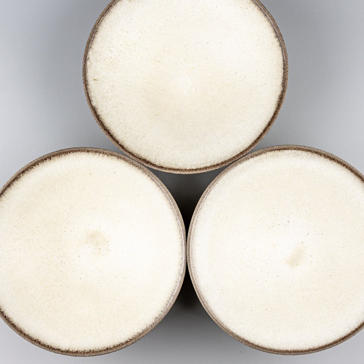 Arrangement of handmade ceramic plates for fine dining and artistic food presentation.