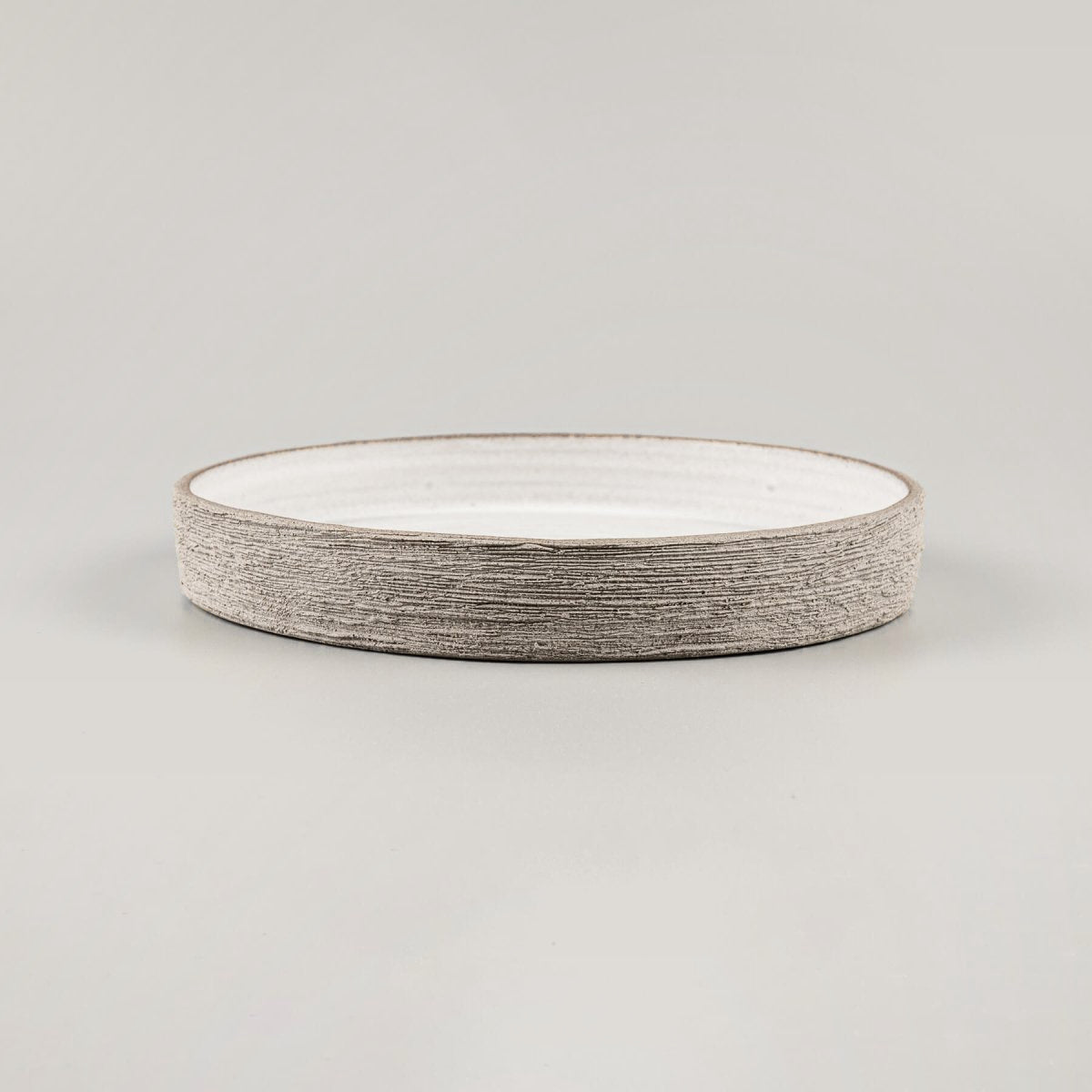 Luxury stoneware plate with straight edges, flat base, and artisan-carved rim for premium culinary service.