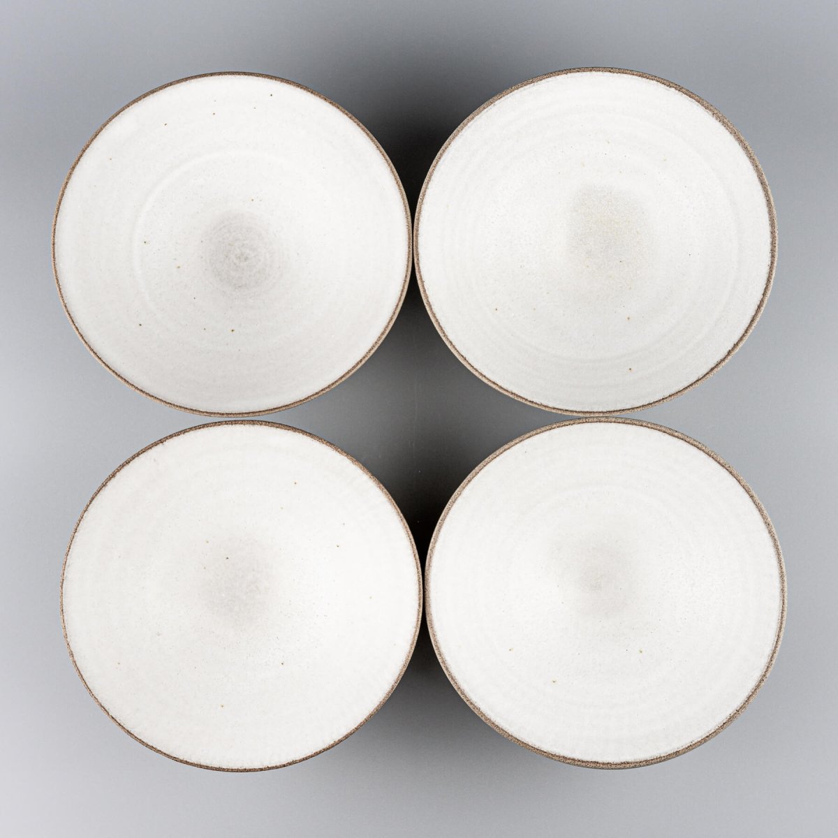 Set of four handcrafted ceramic bowls ideal for boutique hotels or home chefs.