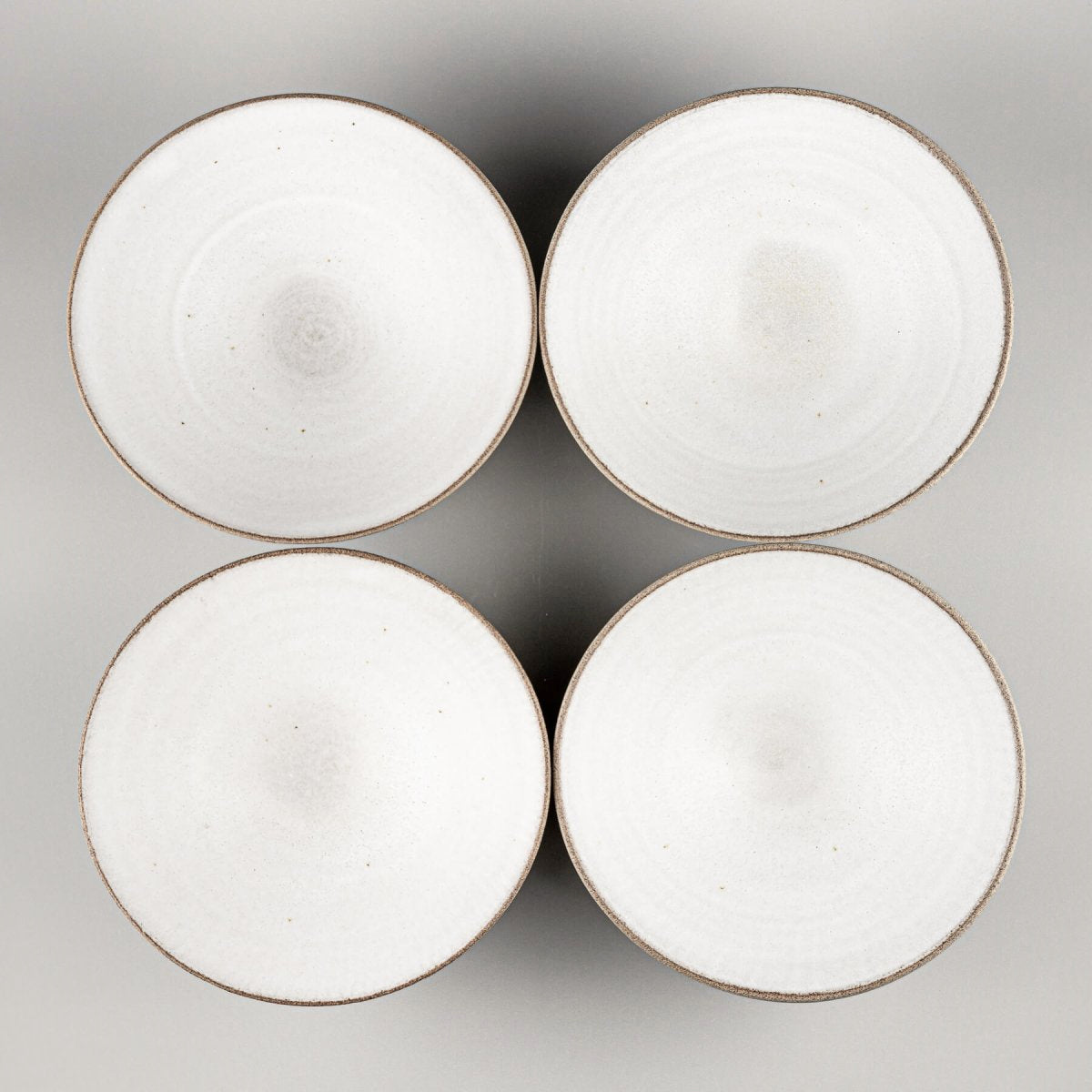 Set of four handcrafted ceramic bowls ideal for boutique hotels or home chefs.