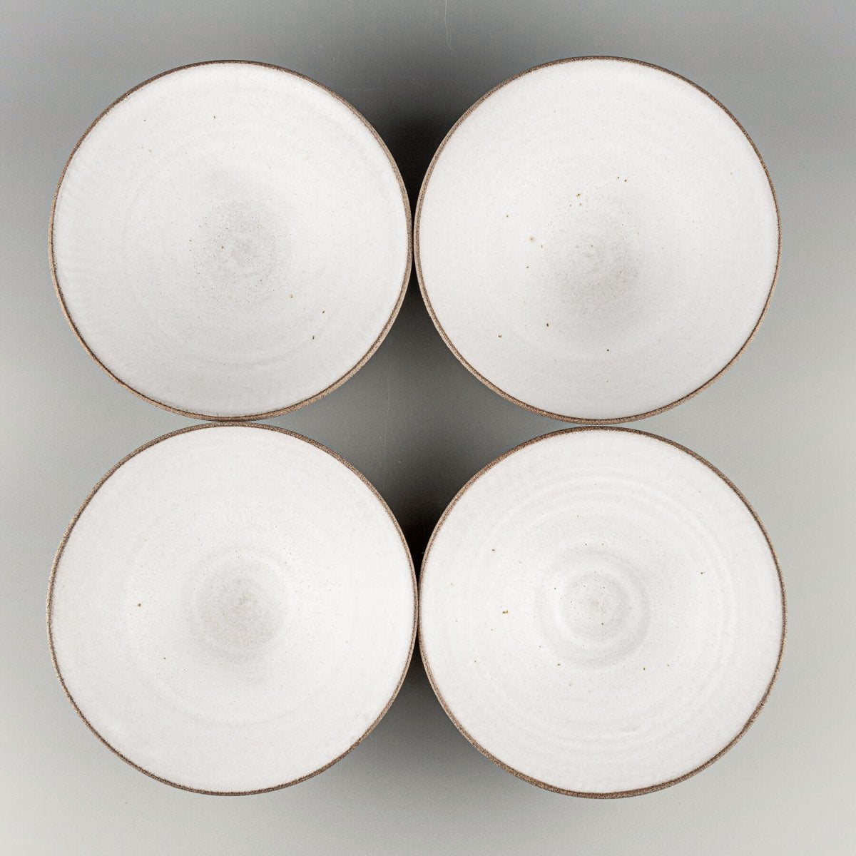 Set of stoneware bowls arranged for restaurant or boutique hotel presentation.
