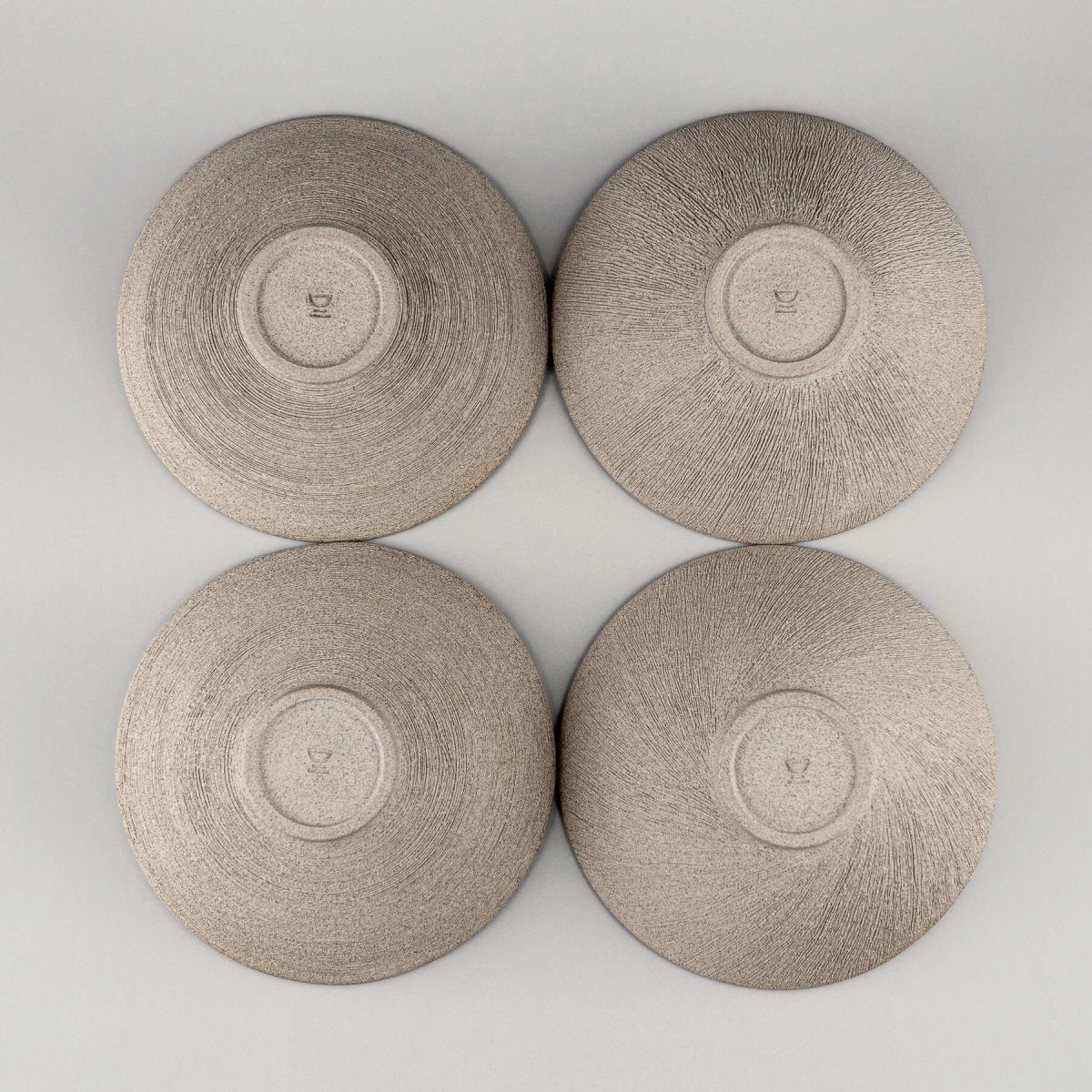Set of four handcrafted bowls arranged in a group for kitchen or restaurant use.