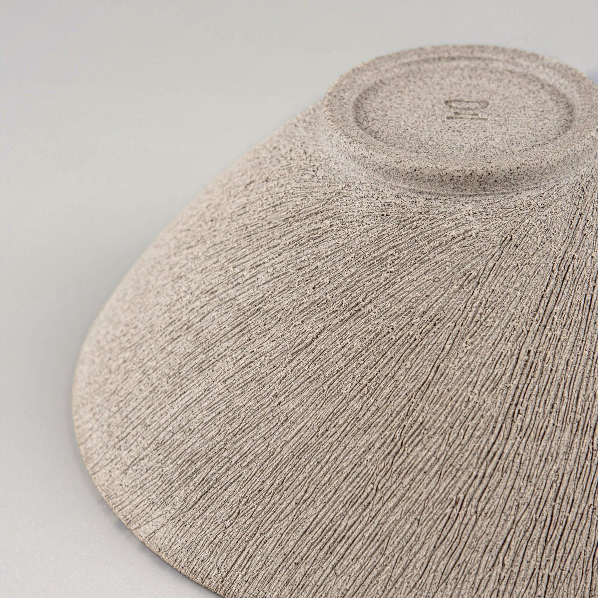Angled view showing the fine craftsmanship and natural ceramic finish.