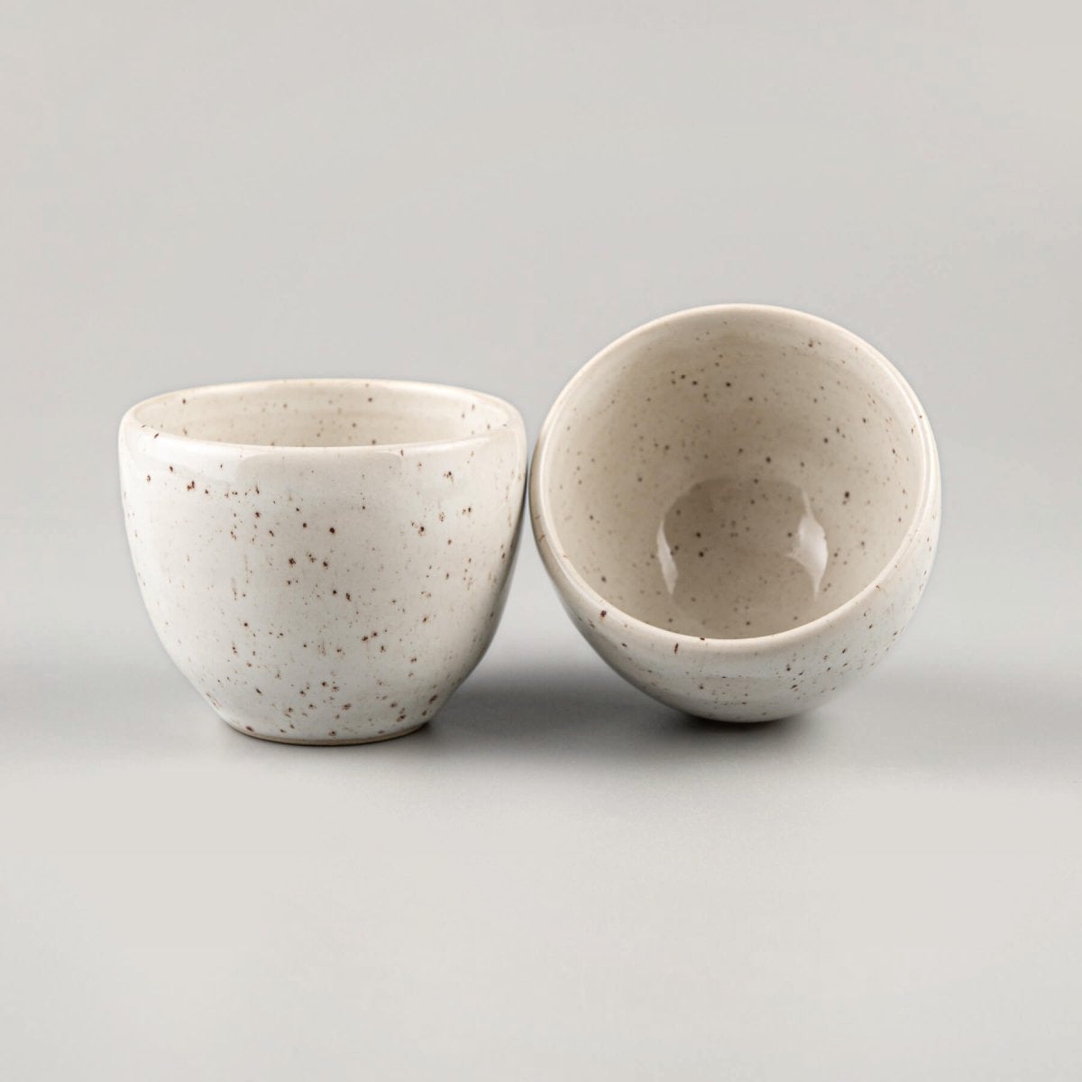 Side view of artisanal stoneware coffee cup in ivory glaze, suitable for restaurants and home kitchens.