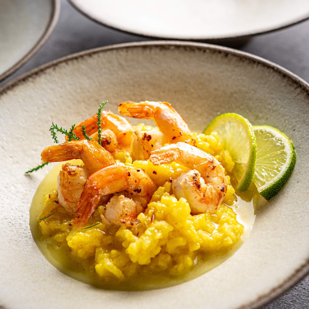 Gourmet dish plated on artisanal ceramic plate with white glaze for fine dining service.