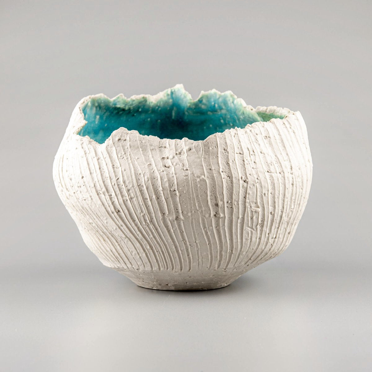 Handmade stoneware vase featuring a textured white exterior and a turquoise glazed interior, perfect for luxury home decor.