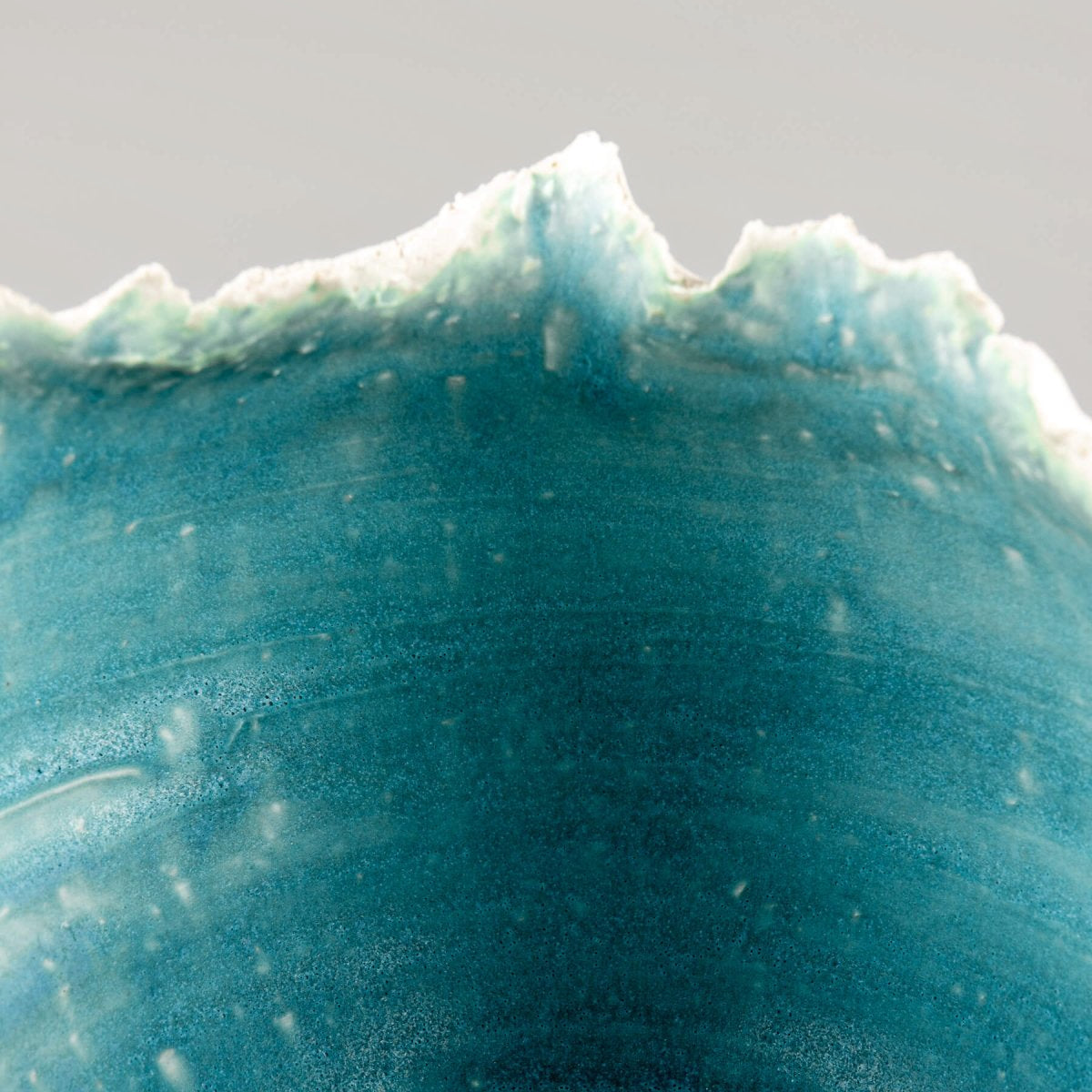Elegant handmade stoneware vase with natural white exterior and striking turquoise interior for interior design.