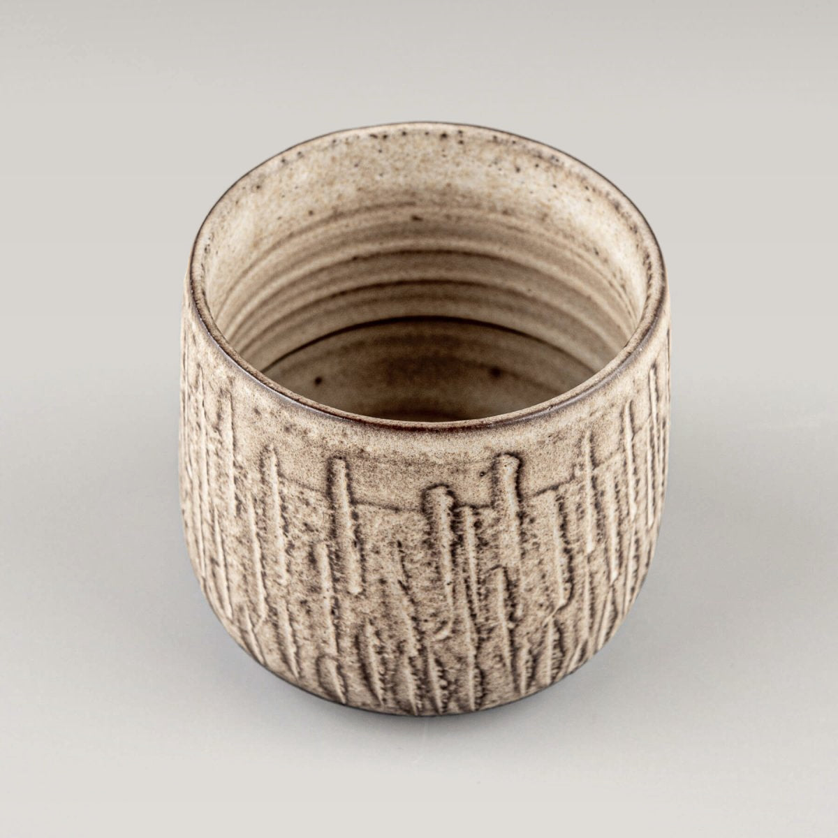 Top view of handcrafted ceramic mugs showing textured interior and artisan stoneware design.
