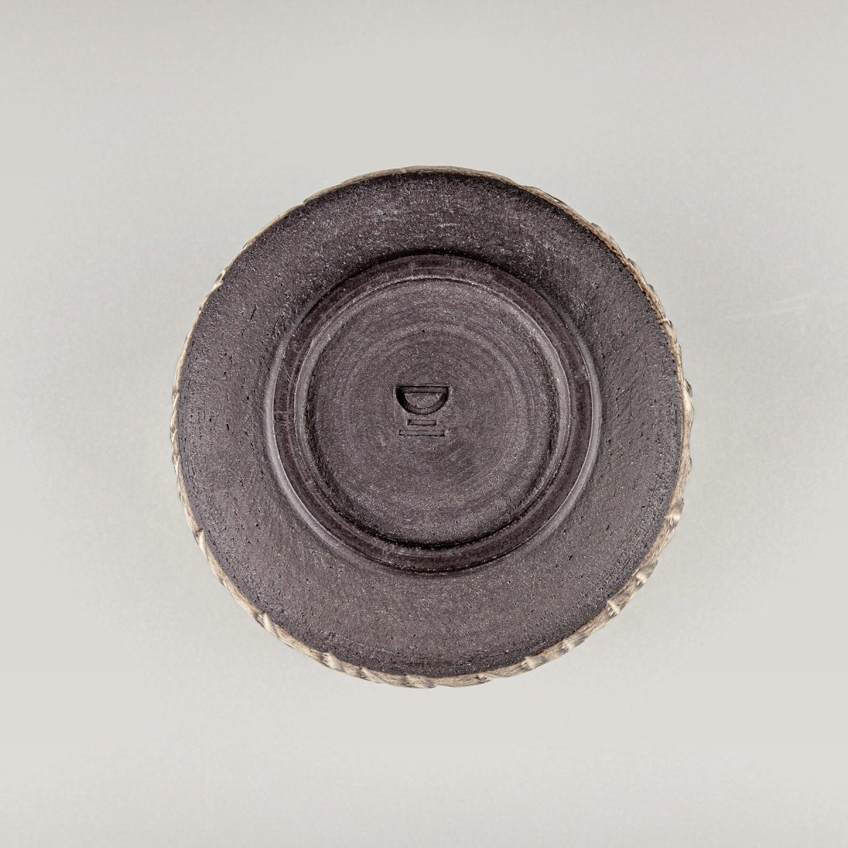 Bottom view of handcrafted ceramic mug showing potter’s wheel finish and stable base.